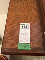 Close-up of wooden cabinet top with size label 37x18x32 inches and handwritten notes 'Singer Sewing Machine'.