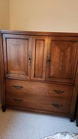 Front view of Century Furniture chest showing two top paneled doors and two larger bottom drawers.