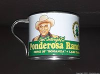 Front side of metal collectible cup showing Ben Cartwright portrait and Ponderosa Ranch branding.