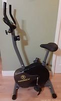 Full side view of Marcy stationary exercise bike showing seat, pedals, frame, and handlebars.