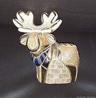 Close-up image of Derosa 18kt gold moose figurine showing detailed craftsmanship and enamel accents.