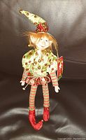 Front view of 'Santa's Little Rascals' elf doll showing full outfit and detailed facial features