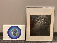 Two framed wall art pieces side by side: a koi fish illustration (left) and a water photograph with handwritten poem (right).