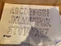 Printed sheet showing cartoon-style alphabet A-Z with the copyright logo Grand Persian MGM Grand Hotel Las Vegas 1974 in lower left corner.
