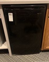 Front view of small black refrigerator with Danby Designer logo, labeled as lot 842.