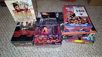 Full view of seven trading card boxes including Terminator 2 Judgment Day, The Phantom, Viper, American Gladiators, Hook, Supergirl.