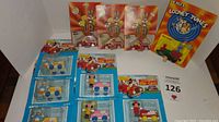 Full view of lot showing multiple Disney and Looney Tunes die cast cars carded and sealed on backing cards