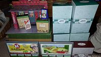 Full overview of KC Garage model, accessory boxes, billboards, and signs grouped on a table for pickup showing condition and arrangement.