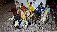Seven Hartland cowboy and western figures mounted on horses in various colors and poses.