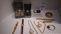 Overview of all watches and jewelry including boxed watches and loose pieces on white background