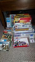 Photo showing a variety of boxed vintage military and historical model kits stacked on floor, majority are soldier figures and infantry.