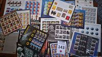 Overview of assorted stamp sheets laid flat