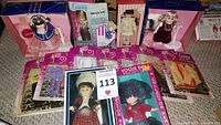 Photo of boxed dolls and multiple packages of doll clothing accessories