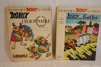 Both Asterix hardcover comic books lying flat showing front covers and titles
