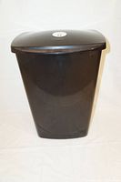 Front view of the black plastic garbage bin with closed lid.