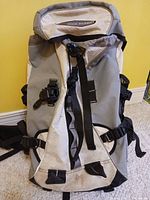Front view of High Sierra backpack in gray/black showing straps and buckles.