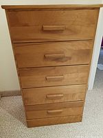 Front view of the highboy chest showing five drawers with rectangular wooden handles.