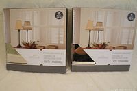 Two boxes each containing a 6-piece set of Threshold frameless mirrors, labeled as new and still in box.