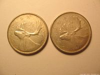 Photo of the obverse sides of 1961 and 1964 Canadian 25 cent silver coins showing the caribou design and the year.