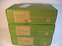 Stack of three KiwiCo green boxes labeled Marble Timer, Music Machines, and Ice Lab.