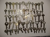 Overview showing 63 old flat keys with varied designs, conditions, and sizes.