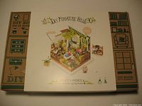 Box with full kit branding and a colorful illustration of the assembled miniature garden room with furniture and accessories.