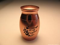 Full view of the mini copper-tone keepsake urn showing inscription and butterfly design