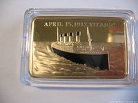 Front side of gold plated Titanic commemorative bar showing ship image and date 'April 15, 1912 Titanic'