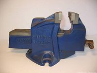 Side profile of blue cast iron benchtop anvil vise showing solid construction and jaw width.