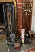 Full lot showing fireplace screen, brass tool set, candle, matches, and small candle holder.