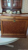 Exterior front view of closed jewelry box on table