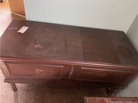Top view showing the rectangular cedar chest with dark wood finish and discoloration marks.