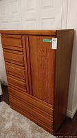 Front and side view of wood armoire showing overall layout and finish