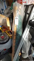 Photo of the wrapped wood frame and green fabric double hammock packed and tagged.