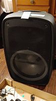Front view of the portable Ion speaker showing speaker grille and handle on top.