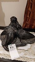 Front view of the soapstone statue showing three walruses grouped with detailed textures and expressions.