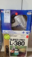 Front view of the boxed Lemmer Super Pro L-380 air impact wrench and spray gun showing product window and label with product name, features, and image of spray gun in use.
