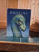Front view of green dragon illustration slipcase with series title The Inheritance Cycle by Paolini