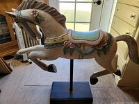 Full left-front view of the carved horse on its stand