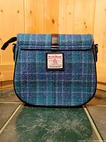 Front view of the blue plaid Harris Tweed purse showing label and plaid pattern.