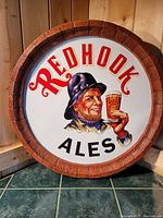 Photo of the large round Redhook Ales beer sign showing the man holding a beer glass and the Redhook Ales logo clearly visible.