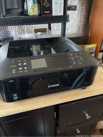 Front and angled side view of Canon MX882 printer showing overall condition and design