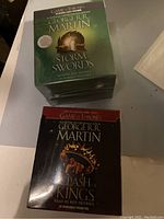 Top view of two boxed audiobook sets for Storm of Swords and A Clash of Kings by George R.R. Martin.