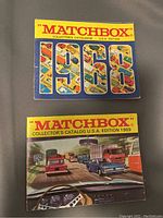 Front covers of the two Matchbox collector catalogs from 1968 and 1969 editions lying on a surface.