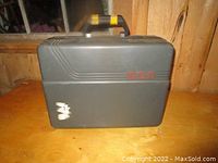 Black hard carrying case with handle, showing red RCA lettering and signs of wear.