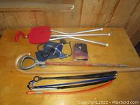 Full view of all items including two folding seats, blood pressure gauge, wooden cane, gloves, and four long shoe horns spread on a wooden surface.