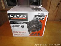 Box packaging of RIDGID 2-1/2" x 20' Dual-Flex Tug-A-Long Locking Hose showing sizing and locking hose details.