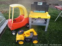 Photo showing all three items: red and yellow ride-on car, yellow and black toy excavator truck, and grey and yellow kids workbench.