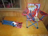 Two Spider-Man kids folding chairs, one folded and one opened, showing the red, blue, and printed Spider-Man design with mesh cup holders