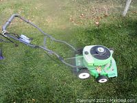 Full side view of green Lawnboy push lawnmower showing handlebar, wheels, and engine cover.
